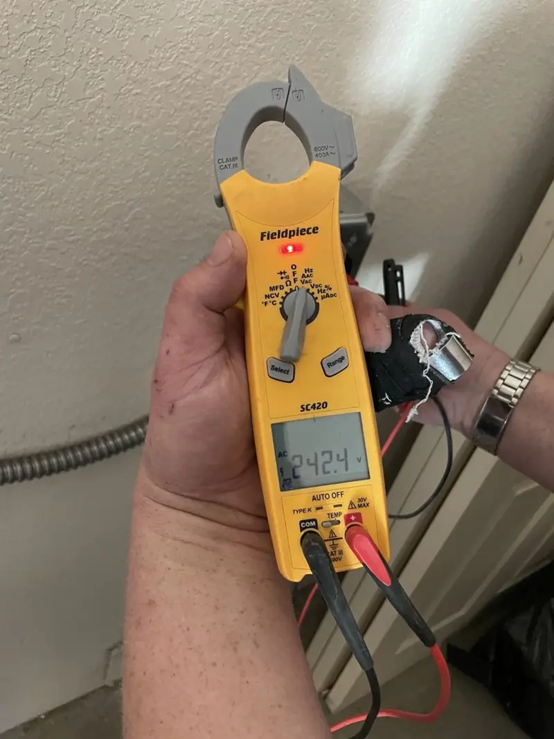 Voltage testing with clamp meter during Outlet Installation in Bradley